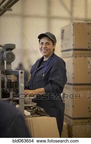 Hispanic woman working in bottling factory View Large Photo Image Picture - Hispanic woman working in bottling factory. Fotosearch