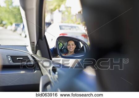 Stock Photograph - Image of Hispanic woman in car’s side mirror. Fotosearch