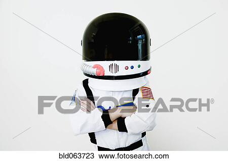 Stock Image - Mixed race boy in astronaut costume. Fotosearch