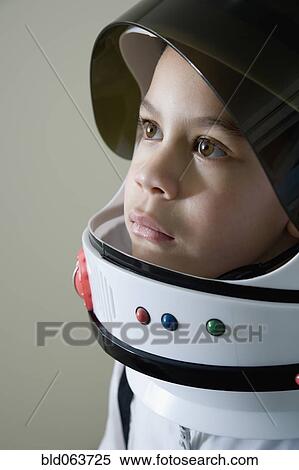 Stock Photography - Mixed race boy in astronaut costume. Fotosearch