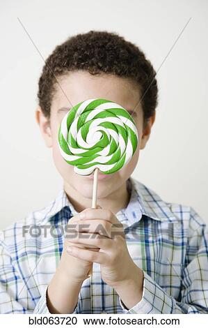 Mixed race boy with oversized lollipop View Large Photo Image Stock Image - Mixed race boy with oversized lollipop. Fotosearch