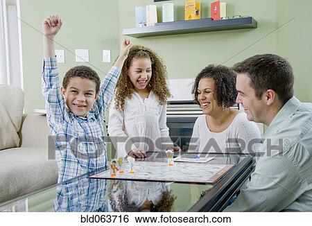 Mixed race family playing board game View Large Photo Image Stock Photograph - Mixed race family playing board game. Fotosearch