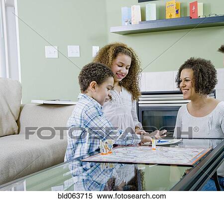 Mixed race family playing board game View Large Photo Image Stock Photography - Mixed race family playing board game. Fotosearch