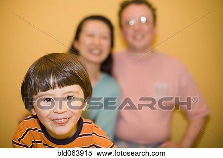 Stock Photography - Mixed race family smiling. Fotosearch