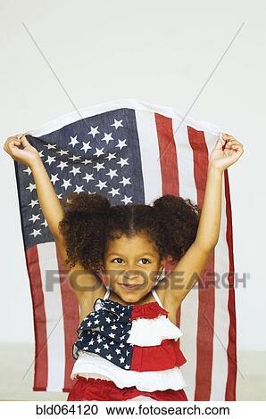 Mixed race girl holding American flag in an American flag dress View Large Photo Image Stock Image - Mixed race girl holding American flag in an American flag dress. Fotosearch