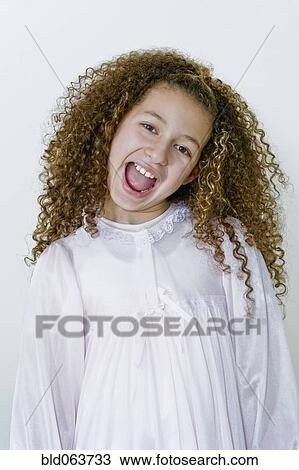 Stock Image - Mixed race girl in nightgown. Fotosearch