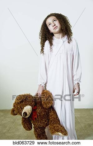 Mixed race girl in nightgown with teddy bear View Large Photo Image Stock Photo - Mixed race girl in nightgown with teddy bear. Fotosearch