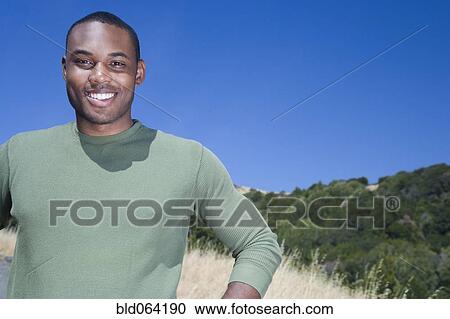 Mixed race man standing in rural area View Large Photo Image Stock Image - Mixed race man standing in rural area. Fotosearch