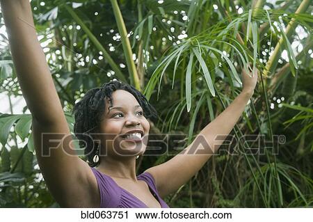 Mixed race woman outdoors with arm raised View Large Photo Image Stock Image - Mixed race woman outdoors with arm raised. Fotosearch
