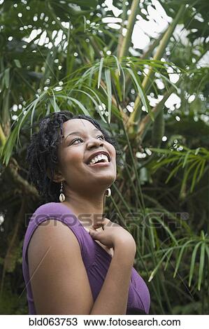 Stock Image - Mixed race woman smiling outdoors. Fotosearch