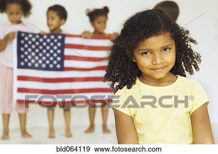 Stock Photo - Multi-ethnic children holding American flag. Fotosearch