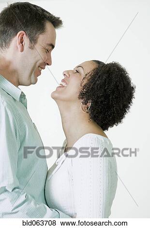 Multi-ethnic couple hugging View Large Photo Image Stock Photo - Multi-ethnic couple hugging. Fotosearch