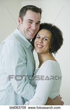 Multi-ethnic couple hugging View Large Photo Image Stock Photo - Multi-ethnic couple hugging. Fotosearch