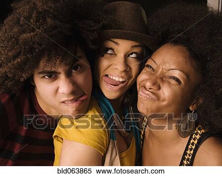 Stock Photography - Multi-ethnic friends making faces. Fotosearch