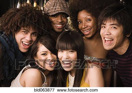 Stock Photo - Multi-ethnic friends posing in nightclub. Fotosearch