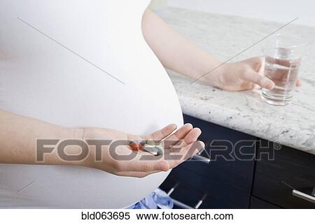 Pregnant Asian woman taking vitamins View Large Photo Image Stock Photography - Pregnant Asian woman taking vitamins. Fotosearch