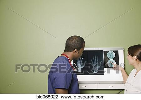 African doctor and nurse examining x-rays View Large Photo Image Stock Image - African doctor and nurse examining x-rays. Fotosearch