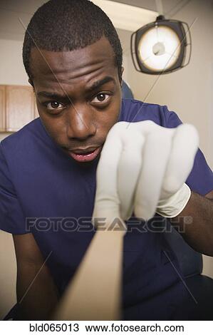 African doctor examining patient with tongue depressor View Large Photo Image Stock Image - African doctor examining patient with tongue depressor. Fotosearch
