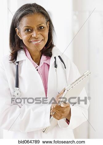Stock Photo - African doctor standing with medical chart. Fotosearch