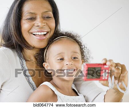 African grandmother and granddaughter smiling for self-portrait View Large Photo Image Picture - African grandmother and granddaughter smiling for self-portrait. Fotosearch