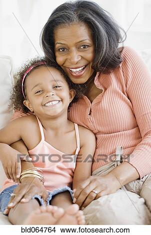 Picture - African grandmother hugging granddaughter. Fotosearch