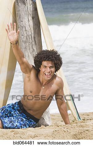 African man at beach with surfboard View Large Photo Image Stock Image - African man at beach with surfboard. Fotosearch