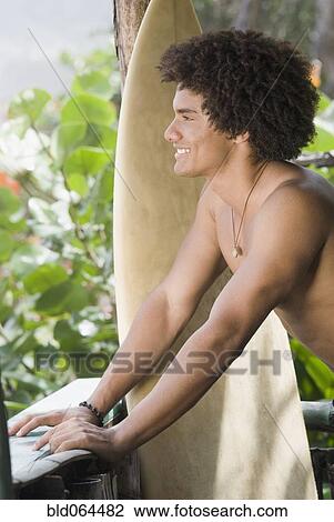 African man at beach with surfboard View Large Photo Image Stock Image - African man at beach with surfboard. Fotosearch