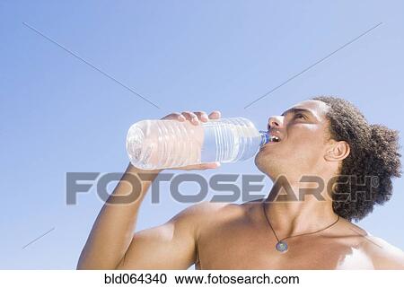 Stock Image - African man drinking water. Fotosearch