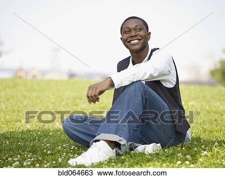 Stock Image - African man enjoying day in the park. Fotosearch