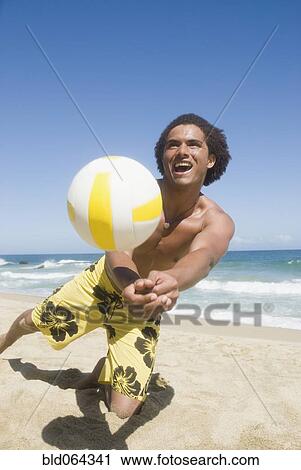 African man playing volleyball at beach View Large Photo Image Stock Image - African man playing volleyball at beach. Fotosearch
