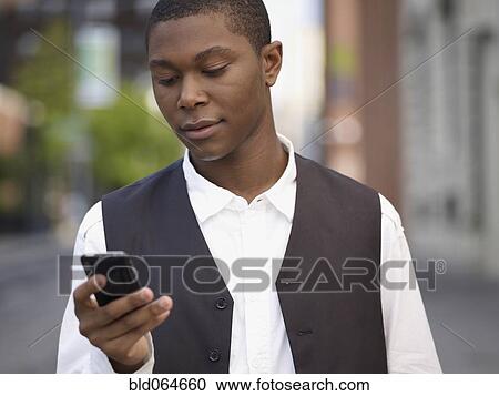 African man text messaging on cell phone View Large Photo Image Stock Image - African man text messaging on cell phone. Fotosearch