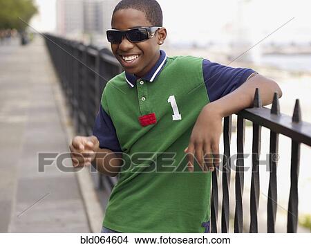 African teenage boy in sunglasses laughing View Large Photo Image Picture - African teenage boy in sunglasses laughing. Fotosearch