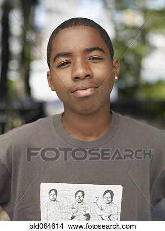 Picture - African teenage boy in urban park. Fotosearch