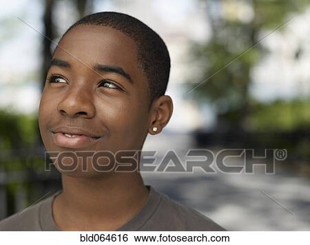Stock Photograph - African teenage boy in urban park. Fotosearch