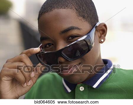African teenage boy peering over sunglasses View Large Photo Image Stock Photography - African teenage boy peering over sunglasses. Fotosearch