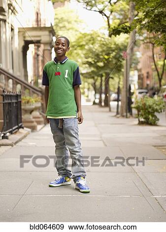 African teenage boy smiling in urban setting View Large Photo Image Stock Photo - African teenage boy smiling in urban setting. Fotosearch