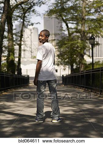 African teenage boy standing in urban park View Large Photo Image Stock Image - African teenage boy standing in urban park. Fotosearch