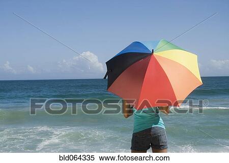 African woman at beach with umbrella View Large Photo Image Stock Photography - African woman at beach with umbrella. Fotosearch