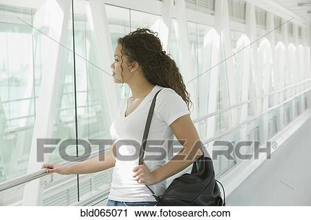 Stock Image - African woman waiting in airport. Fotosearch