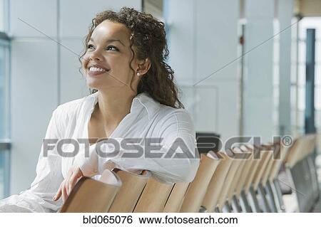 Stock Photograph - African woman waiting in airport. Fotosearch