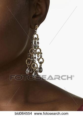 Picture - African woman wearing glamorous earrings. Fotosearch