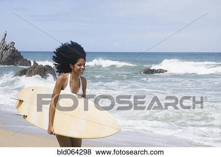 African woman with surfboard at beach View Large Photo Image Stock Photo - African woman with surfboard at beach. Fotosearch