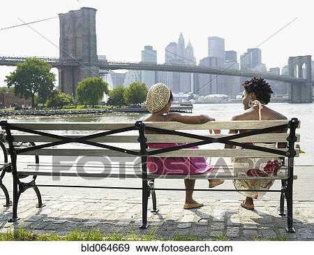 African women sitting on bench at urban waterfront View Large Photo Image Stock Photo - African women sitting on bench at urban waterfront. Fotosearch