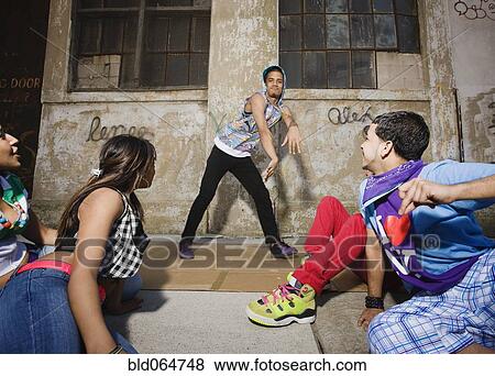 Alternative friends break dancing in urban setting View Large Photo Image Stock Photo - Alternative friends break dancing in urban setting. Fotosearch