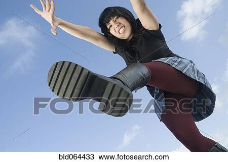 Angry Hispanic woman jumping View Large Photo Image Stock Image - Angry Hispanic woman jumping. Fotosearch