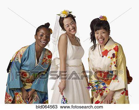 Stock Image - Asian bride with bridesmaids in traditional clothing. Fotosearch