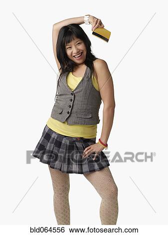 Stock Photograph - Asian woman holding credit card. Fotosearch
