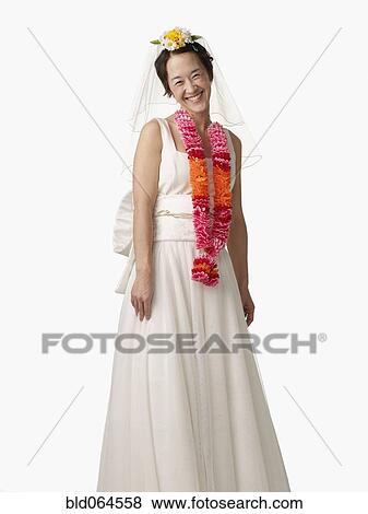 Asian woman in wedding dress and lei View Large Photo Image Stock Photo - Asian woman in wedding dress and lei. Fotosearch