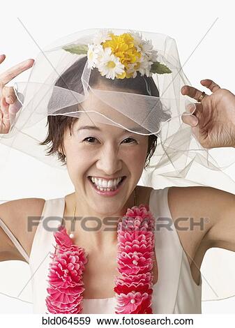 Stock Photo - Asian woman in wedding dress and lei. Fotosearch