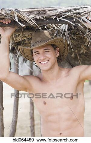 Stock Photo - Bare chested Hispanic man in cowboy hat. Fotosearch